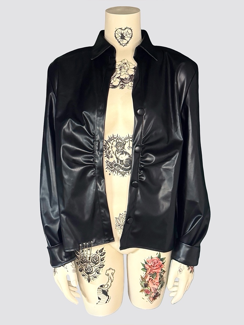 Black leather punk jacket with safety pins and chains
